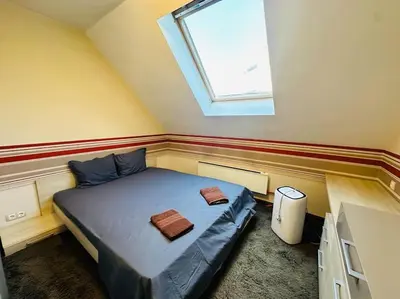 a small bedroom with a bed with a window at Student Town 1BDR APT in Sofia