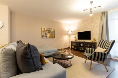 a living room with a couch and a tv at My Place in Sofia