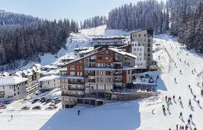 a building on a ski slope in the snow at The Bear Pamporovo in Pamporovo
