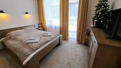 a bedroom with a bed with a christmas tree on it at The Bear Pamporovo in Pamporovo