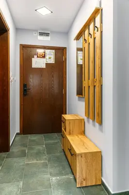 a door and a wooden bench in front of a door at Mursala Pamporovo in Pamporovo