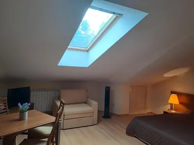 a bedroom with a bed and a skylight at Family Studio 407, Villa park in Borovets