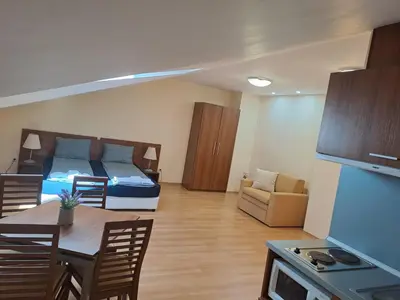 a room with a bed and a kitchen with a table at Family Studio 407, Villa park in Borovets