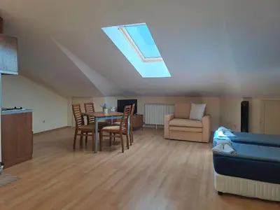 a living room with a table and chairs and a skylight at Family Studio 407, Villa park in Borovets