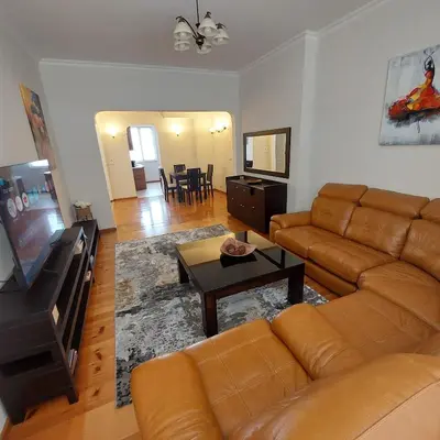 a living room with a couch and a television at La Casa di Sofia in Sofia