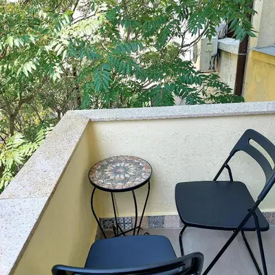 two chairs and a table sitting on a balcony at La Casa di Sofia in Sofia