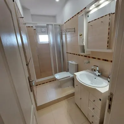 a bathroom with a shower toilet and a sink at La Casa di Sofia in Sofia