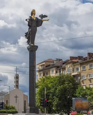 a statue of a woman with a bird on a pole at La Casa di Sofia in Sofia