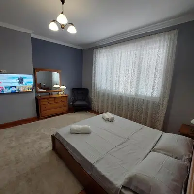 a bedroom with a bed and a window with a mirror at La Casa di Sofia in Sofia