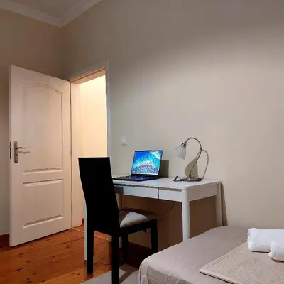 a bedroom with a desk with a laptop computer on it at La Casa di Sofia in Sofia