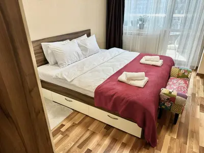 a bedroom with a bed with two towels on it at Sunny & Comfort Apartment next to Tech Park for 4 Guests in Sofia