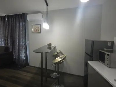 a small room with a table and a tv at Sunshine terrace in Plovdiv