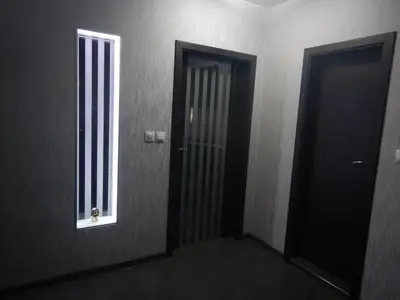 a hallway with two doors and a window at Sunshine terrace in Plovdiv