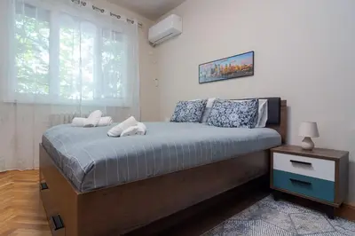 a bedroom with a large bed with a window at Spacious Sofia Condo - Philadelphia LOVE in Sofia