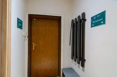 a hallway with a door and a bunch of baseball bats at Spacious Sofia Condo - Philadelphia LOVE in Sofia