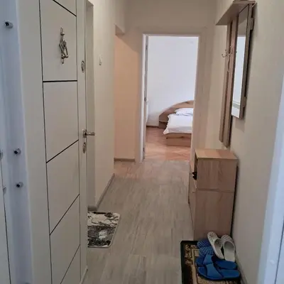 a hallway with a door and a bedroom with a bed at Katerci in Trigrad