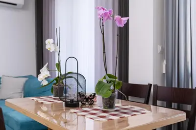 a dining room table with flowers on top of it at 1-Bedroom apartment with Free Private parking in Plovdiv
