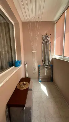 a living room with a table and a vase on the wall at John Apartment 2 in Blagoevgrad