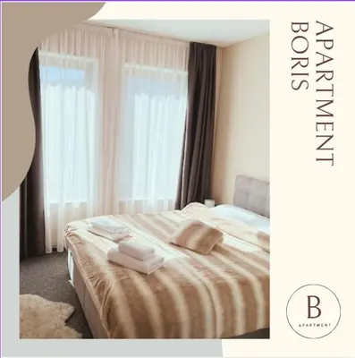 a hotel room with a bed with towels on it at Boris’s Guest Apartment in Chepelare