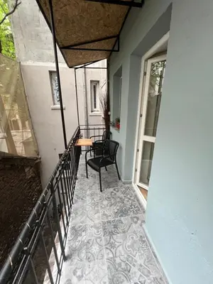 a balcony with a table and a chair on a porch at Sofia Vibes - Friends & Family Stay in Sofia