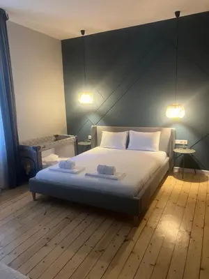 a bedroom with a bed with two towels on it at Sofia Vibes - Friends & Family Stay in Sofia
