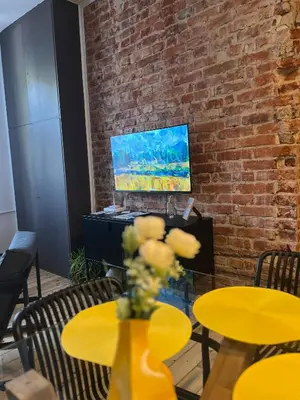 a vase of flowers on a table in a room at Sofia Vibes - Friends & Family Stay in Sofia