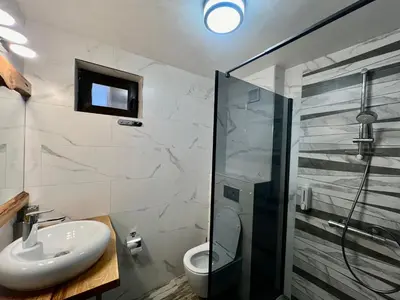 a bathroom with a sink and a shower at Китанова къща in Koprivshtitsa