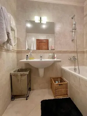 a bathroom with a sink and a tub and a mirror at Wonderful ski resort apartment in Bansko