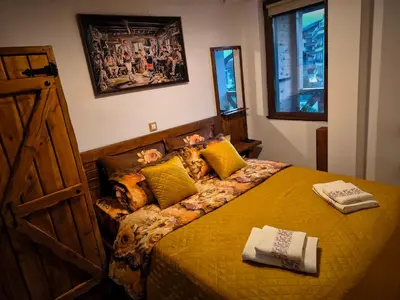 a bedroom with a bed with a book on it at Wooden Paradise Apartment next to Gondola in Bansko