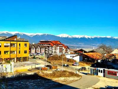 a view of a city with mountains in the background at Wooden Paradise Apartment next to Gondola in Bansko