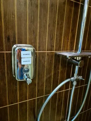 a soap dispenser on the wall of a bathroom at Wooden Paradise Apartment next to Gondola in Bansko