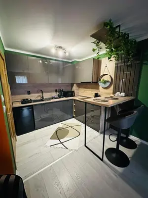 a kitchen with a counter and a table and chairs at Shtastliveca Guest Apartment in Velingrad