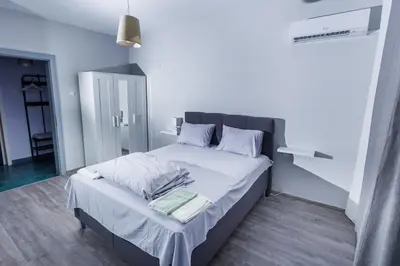 a bedroom with a large bed with white sheets and pillows at Presidential neighbour retreat in Sofia
