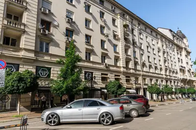 two cars parked in front of a large building at Presidential neighbour retreat in Sofia
