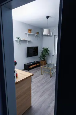a living room with a table and a tv at Presidential neighbour retreat in Sofia