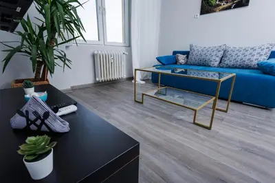 a living room with a blue couch and a table at Presidential neighbour retreat in Sofia