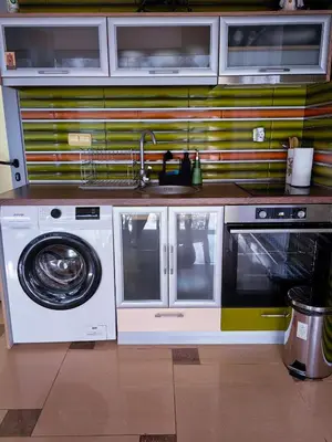 a kitchen with a washing machine and a sink at The View Apartment in Plovdiv