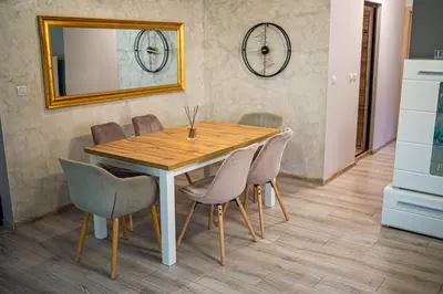 a dining room table with chairs and a mirror at ДиНати in Plovdiv