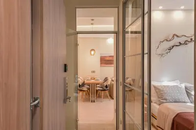 a bedroom with a bed and a dining room with a table at Elegant 1BD Stay on Ekzarh Yosif, Sofia by Flat Mаnager in Sofia