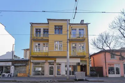 a yellow building on the corner of a street at Elegant 1BD Stay on Ekzarh Yosif, Sofia by Flat Mаnager in Sofia