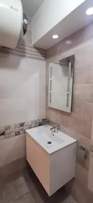 a bathroom with a white sink and a mirror at Blue sea in Sofia