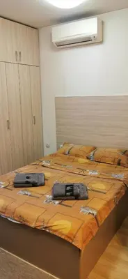 a large bed in a room with two bags on it at Blue sea in Sofia