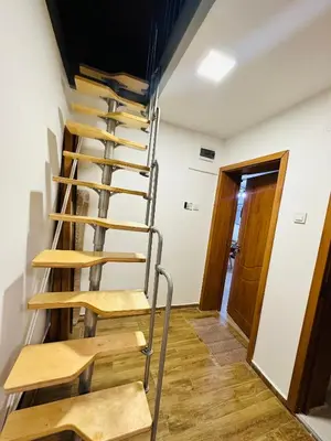 a spiral staircase in a room with a door at Вила Данели in Tsigov Chark