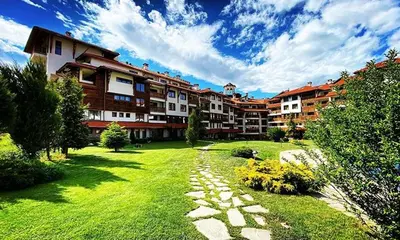 a large apartment complex with a green yard with a pathway at Bansko Royal towers Ski Lift Area in Bansko