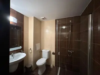a bathroom with a toilet and a shower and a sink at Bansko Royal towers Ski Lift Area in Bansko