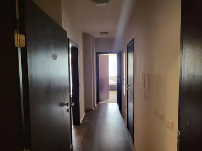 an empty hallway with two doors and a wooden floor at Bansko Royal towers Ski Lift Area in Bansko