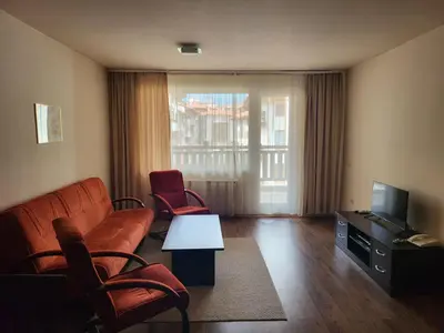 a living room with a couch and chairs and a television at Bansko Royal towers Ski Lift Area in Bansko