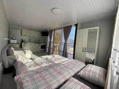 a bedroom with two twin beds and a kitchen at SAFI FOREST village in Dospat