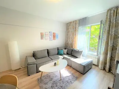 a living room with a couch and a table at Apartment in the Top center next to NDK in Sofia