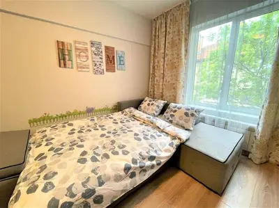 a bedroom with a bed and a window at Apartment in the Top center next to NDK in Sofia